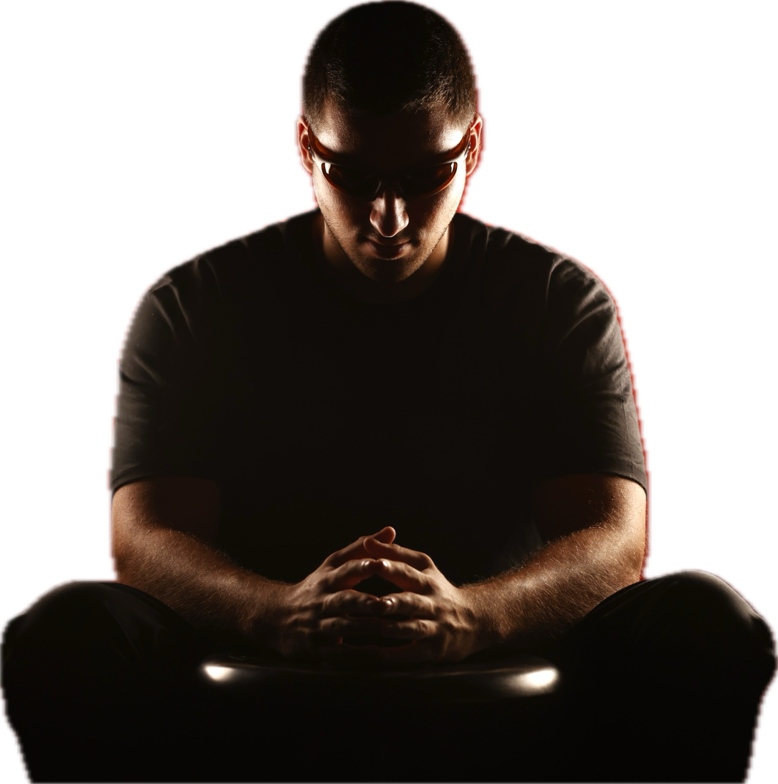 The person behind AKOFFEE, seated with hands clasped